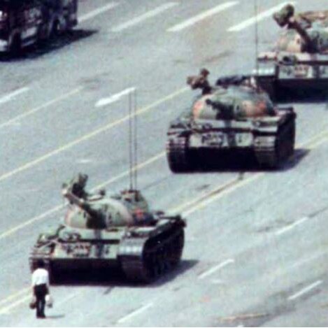 A man stands in front of a tank near Tiananmen Square.
