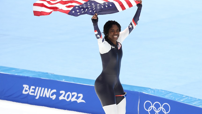 Erin Jackson flies the American flag after winning the gold medal 