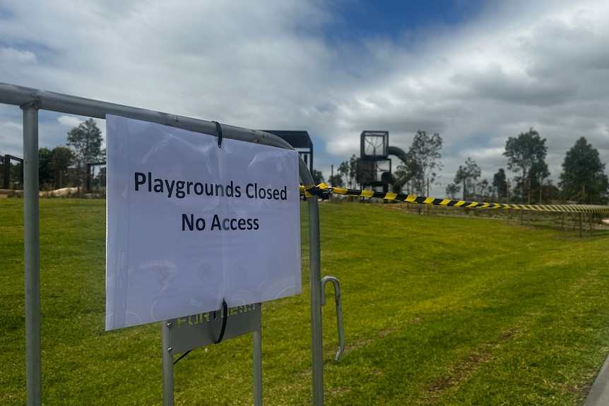 Park grass cordoned off with tape and signs