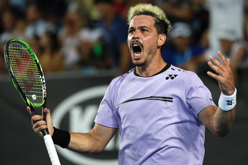 Australia's Alex Bolt celebrates after winning the fourth set against Gilles Simon at the Australian Open