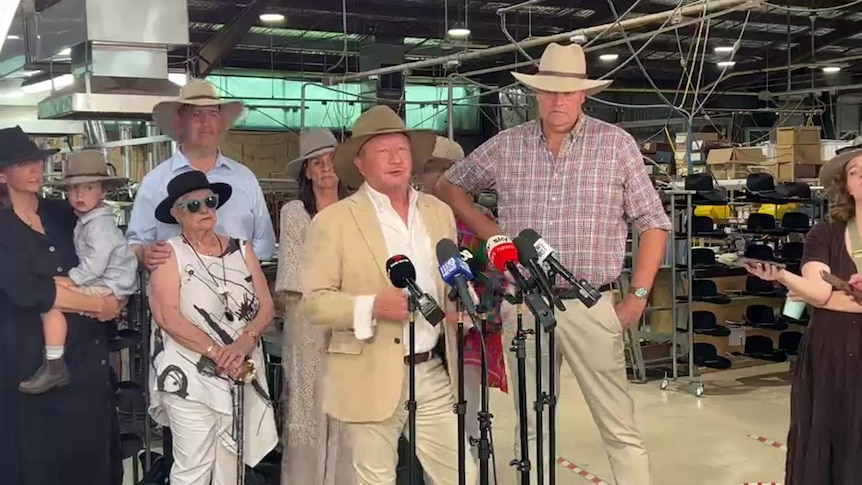 Andrew Forrest speaking to press with the Keir family, who owned Akubra for more than 140 years, standing behind him