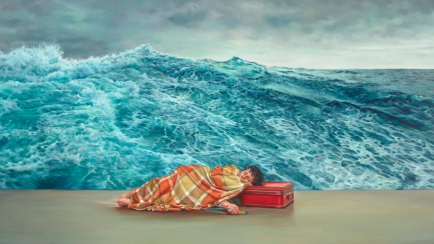 A large oil painting of a woman lying down head on a suitcase wrapped in the blanket, the background is a blue ocean