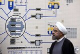 President Hassan Rouhani visits the Bushehr nuclear power plant, with a complex machine in front of him