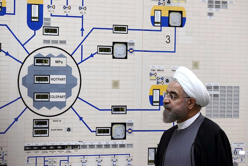 President Hassan Rouhani visits the Bushehr nuclear power plant, with a complex machine in front of him