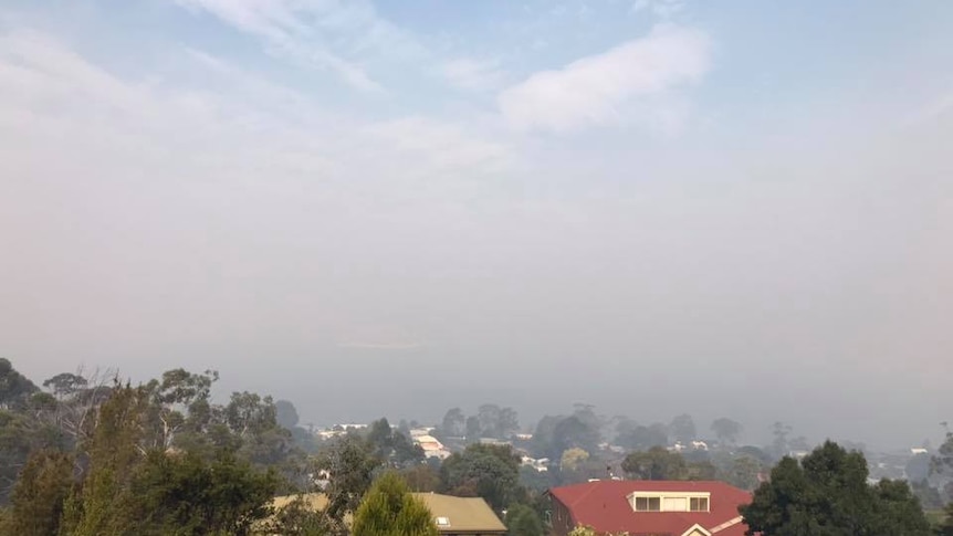 A smoky haze over houses and trees in Hobart