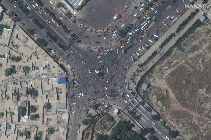 An aerial image of people covering at a roundabout. 