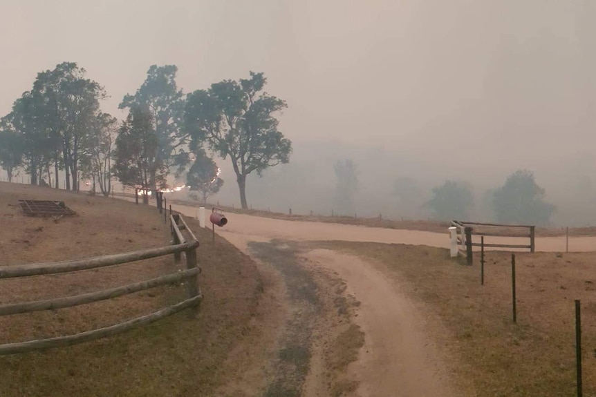 A line of fire approaching the front fence line of a rural property