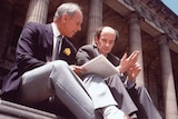 Two men sit on the steps outside the Victorian parliament 