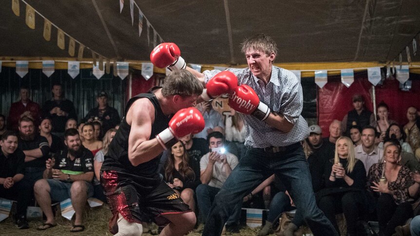 Audience members fight each other in the Fred Brophy boxing tent in Mt Isa.