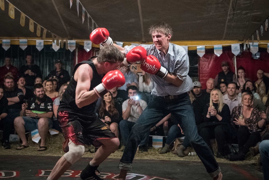 Audience members fight each other in the Fred Brophy boxing tent in Mt Isa.