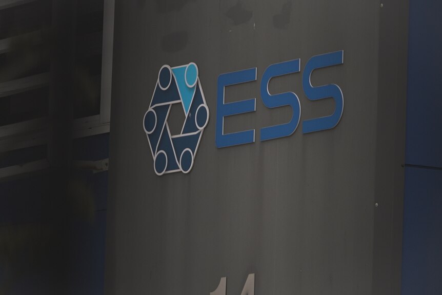 A logo and the letters ESS on the exterior of an office bulding.