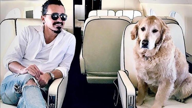 A man and his dog on a private jet