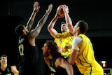 Clean sweep ... the Boomers' AJ Ogilvy shoots over the New Zealand defence.