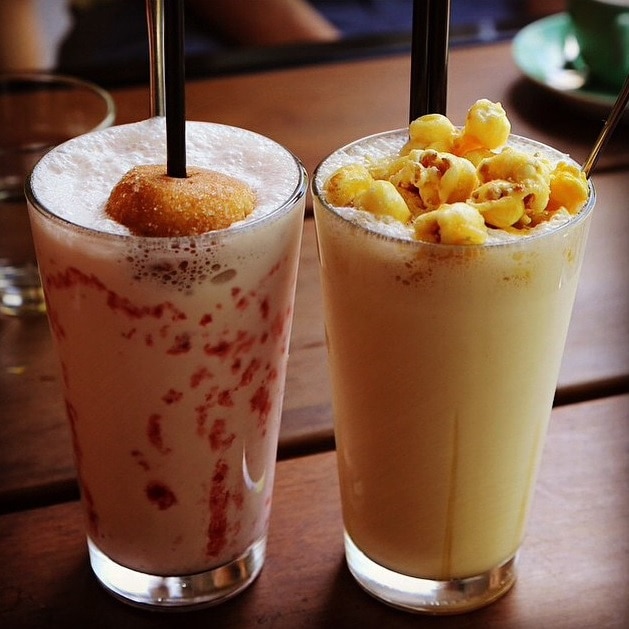 A jam donut shake and a caramel popcorn shake.