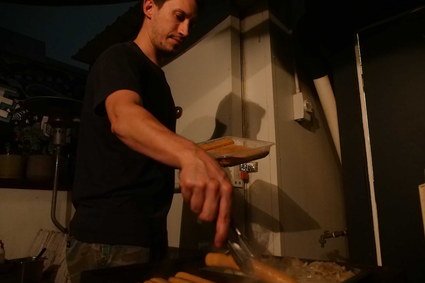 A bar owner celebrates the end of Sydney's lockout laws by holding a sausage sizzle.