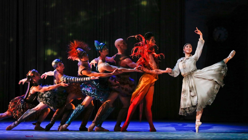 A line of ballet dancers on stage leading to a prima ballerina playing Cinderella