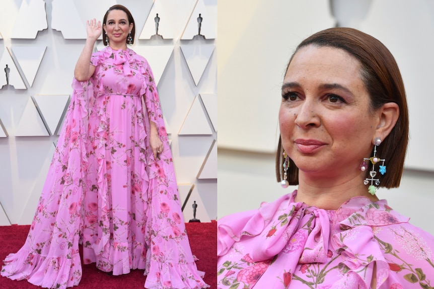 Maya Rudolph wears a pink, floral dress with a long, soft cape.