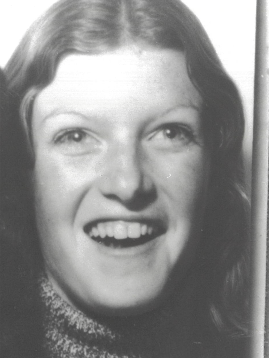 A black-and-white photograph of a young woman, smiling. 