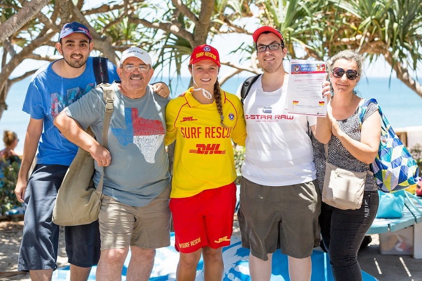 The Ghazal family with surf life saver Emily Neal, who gave them pointers for beach safety.