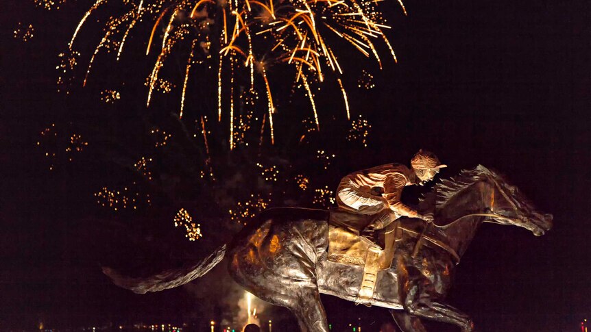 Fireworks explode over the statue of Black Caviar at Nagambie.