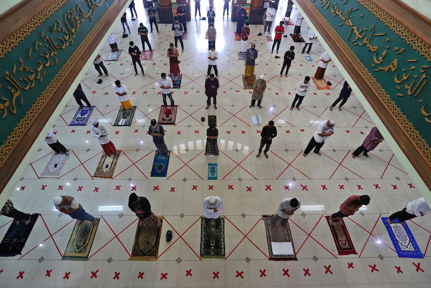 Muslims pray spaced apart to help curb the spread of the coronavirus during a Friday prayer.