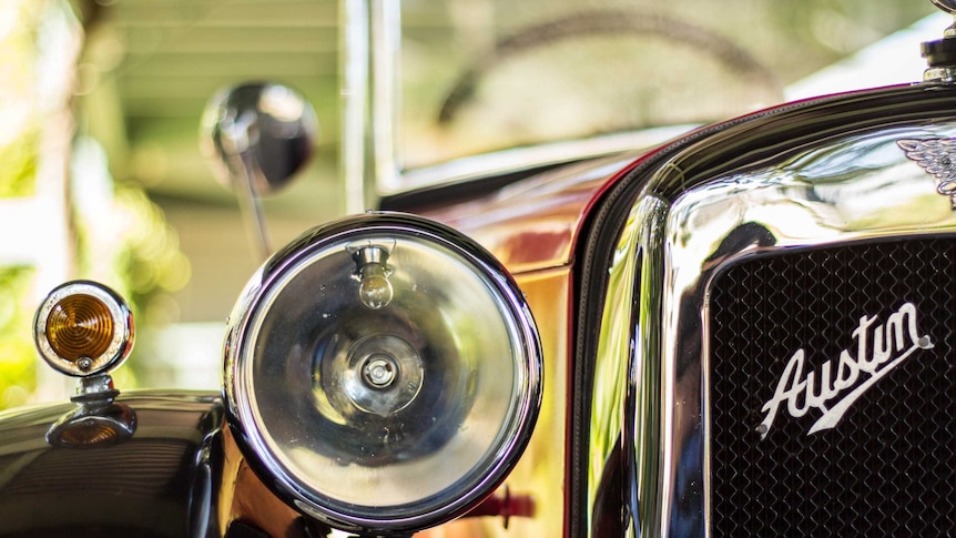 A closeup of an Austin 7 car headlight.