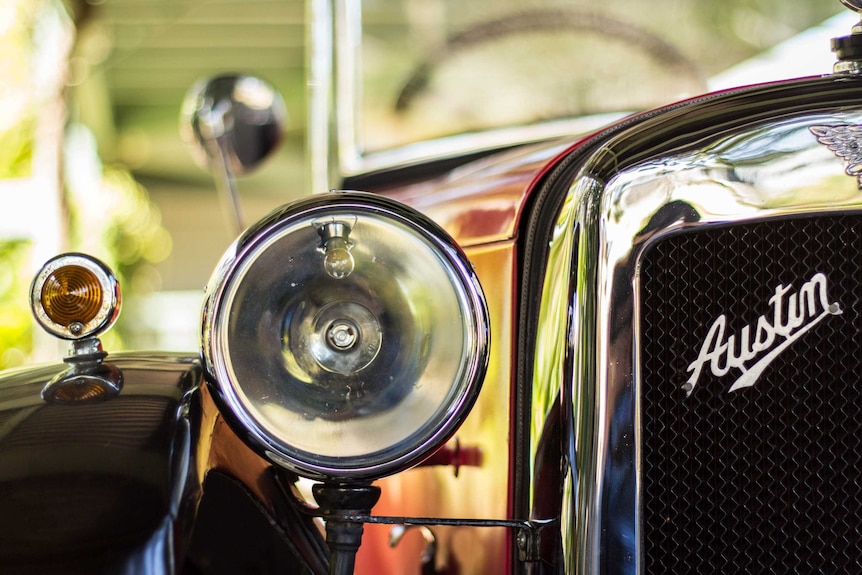 A closeup of an Austin 7 car headlight.