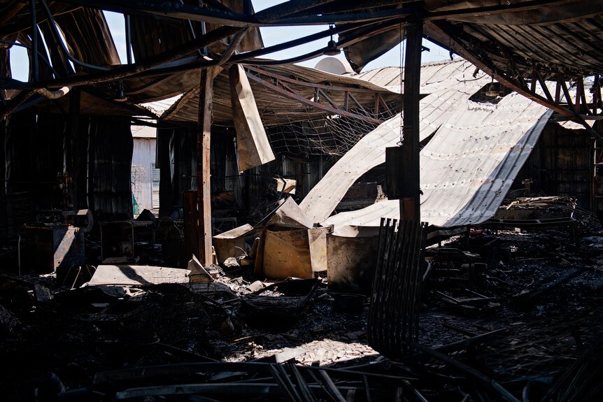 Charred remains of Kerry Kyriacou's joinery business after a fire gutted the building in the industrial area of Woolner