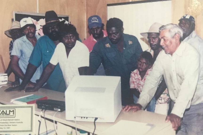 a group of Aboriginal stockmen looking at a computer in 1991.
