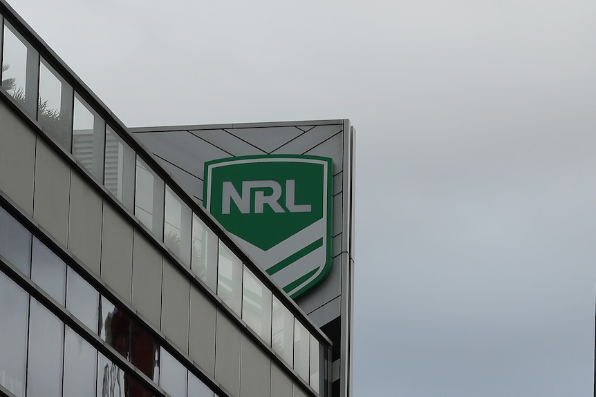 The NRL logo on a building with clouds above it