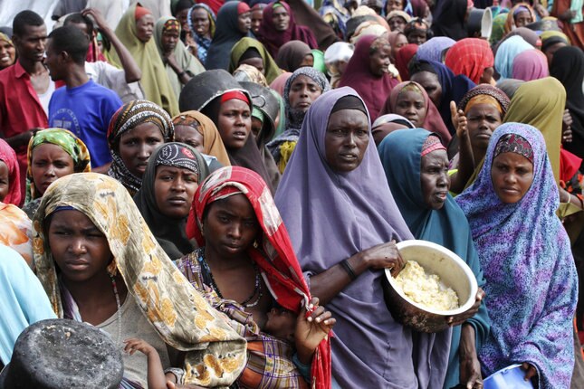 Somali women wait for food (Reuters)