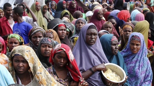 Somali women wait for food (Reuters)