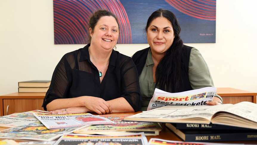 Koori Mail editor Rudi Maxwell and general manager Naomi Moran with past editions of the newspaper