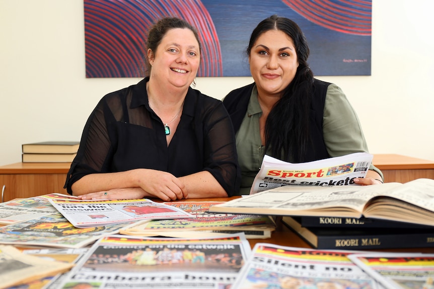 Koori Mail editor Rudi Maxwell and general manager Naomi Moran with past editions of the newspaper