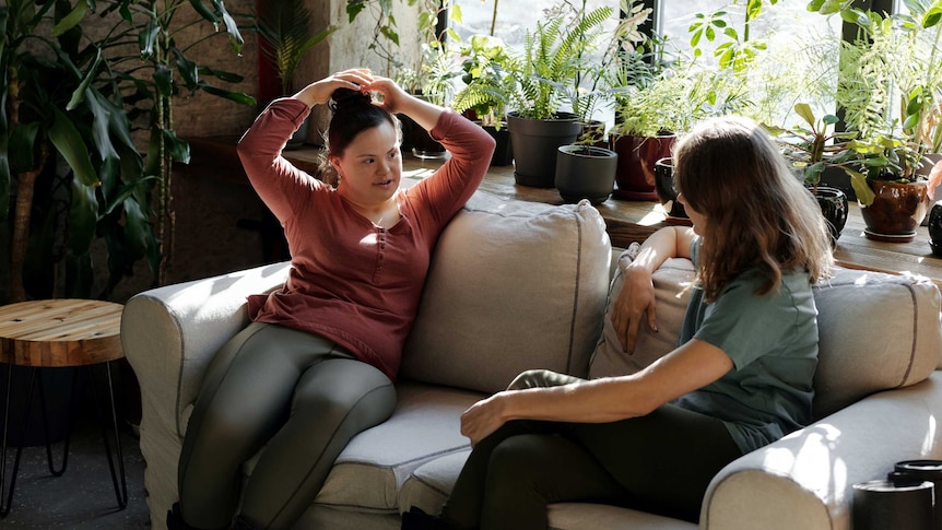 Two women chatting on couch