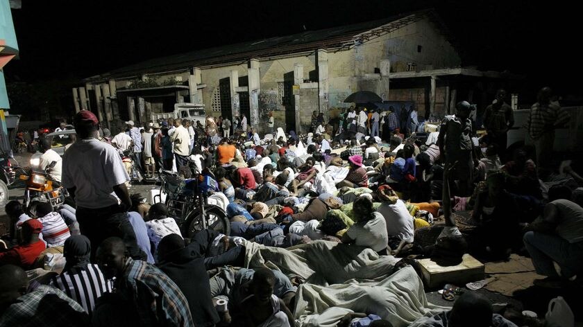 Residents sleep in the street the night after a powerful 7.0 magnitude earthquake
