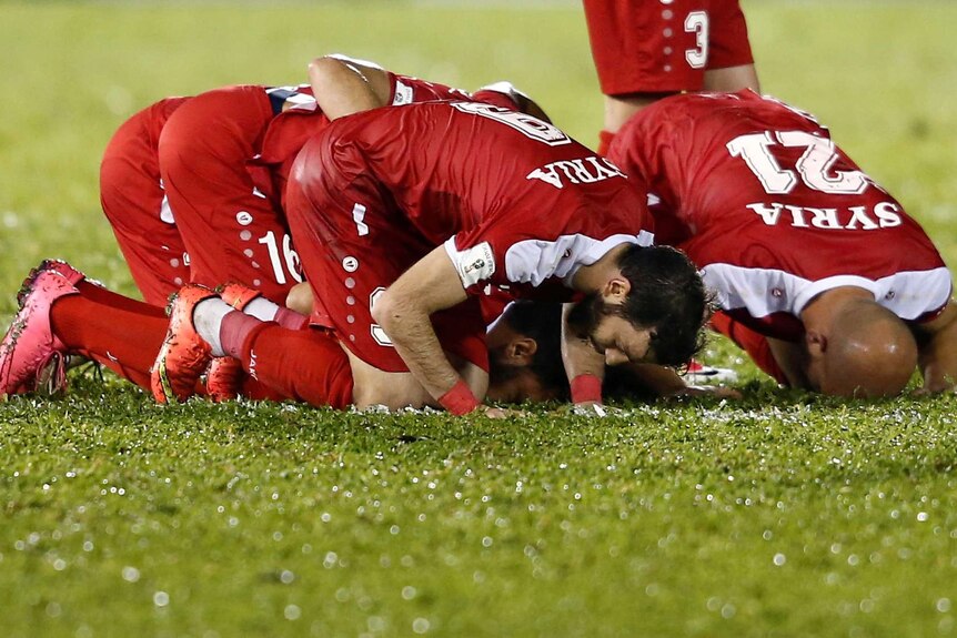 Syria players celebrate equaliser against China