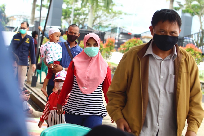 Family members of passengers of the Sriwijaya Air flight arrive at Pontianak airport