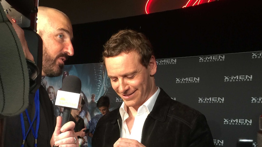 The actor Michael Fassbender speaks to a reporter at a movie premiere in Sydney.