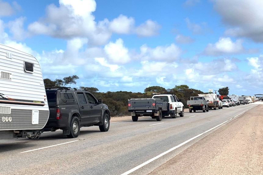 Vehicles lined up behind in each other on a road