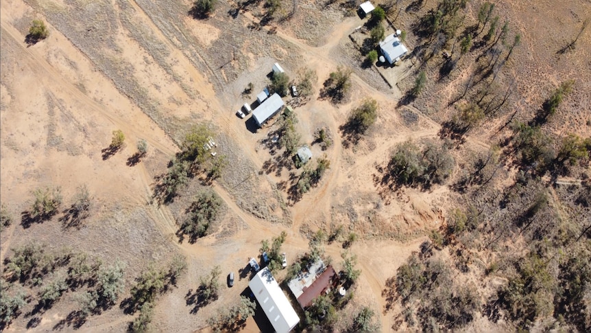 An aerial shot of a farm house and yards.