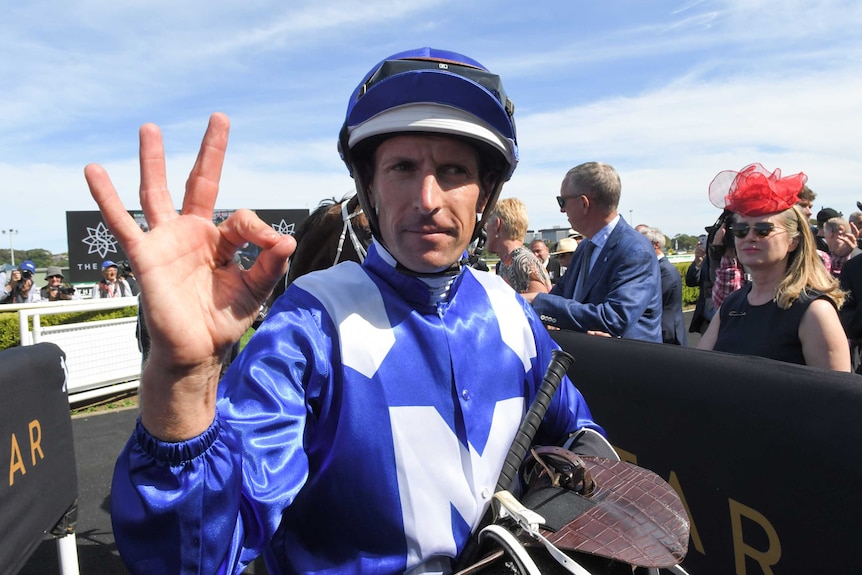 Hugh Bowman makes a gesture with his right hand after Winx won the Apollo Stakes.