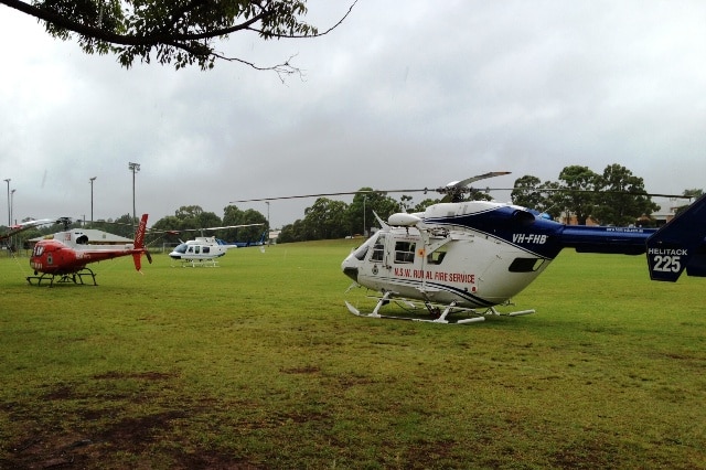 Three helicopters at rest on an oval.