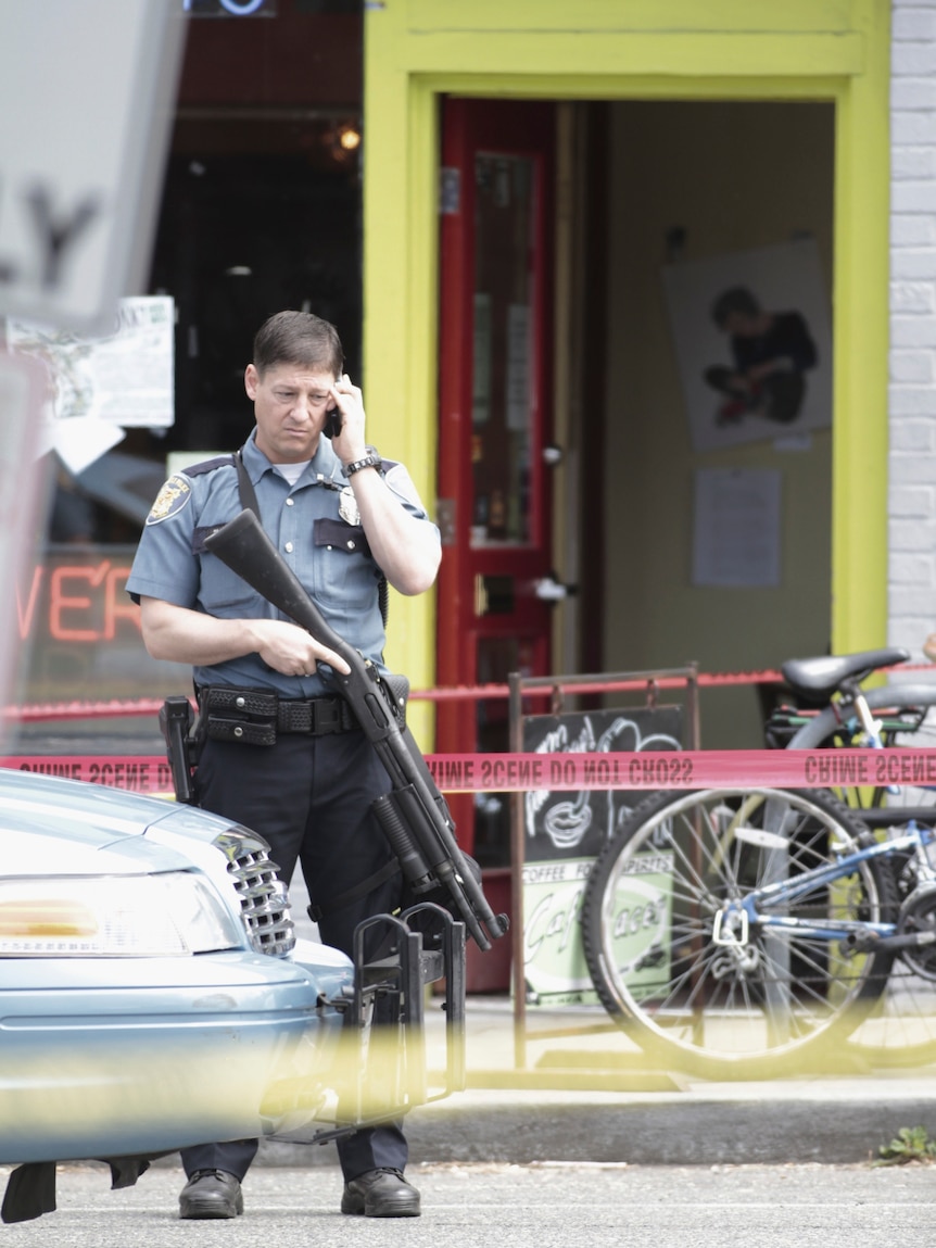 A Seattle police officer at the scene of a shooting