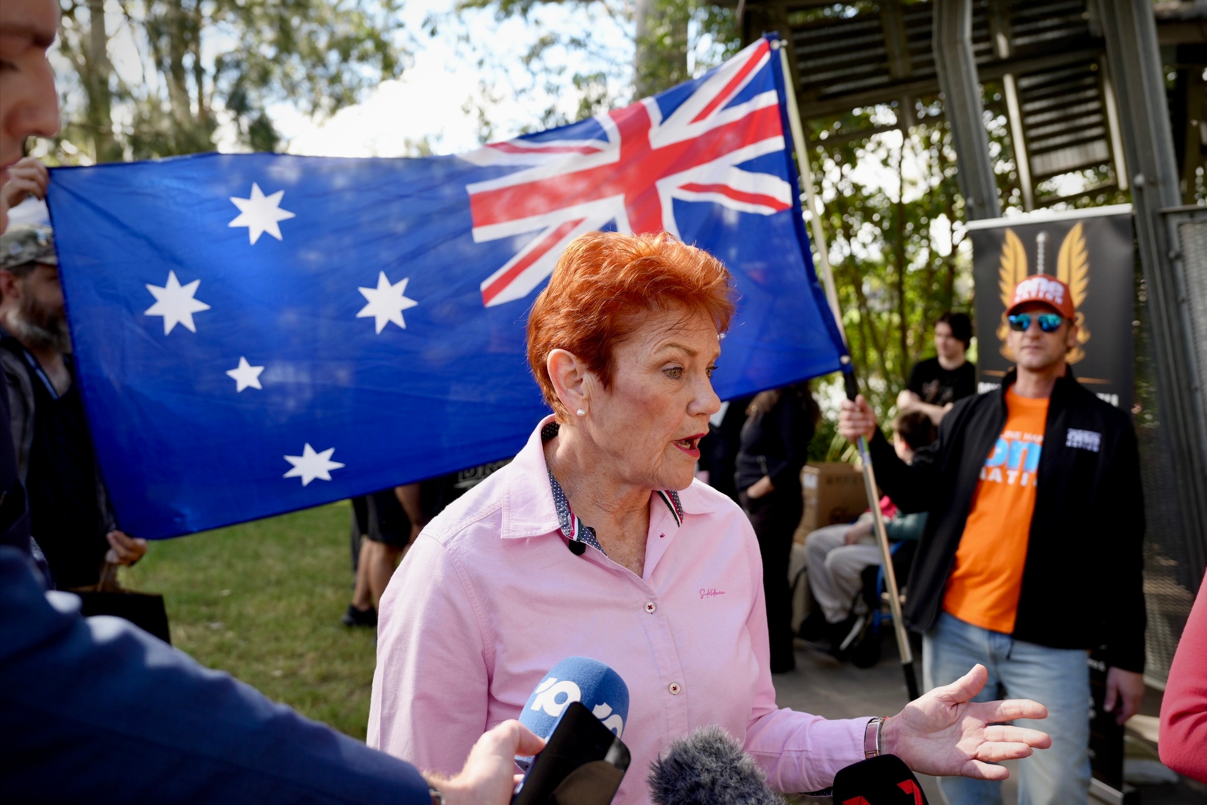 Pauline Hanson speaking into media mics