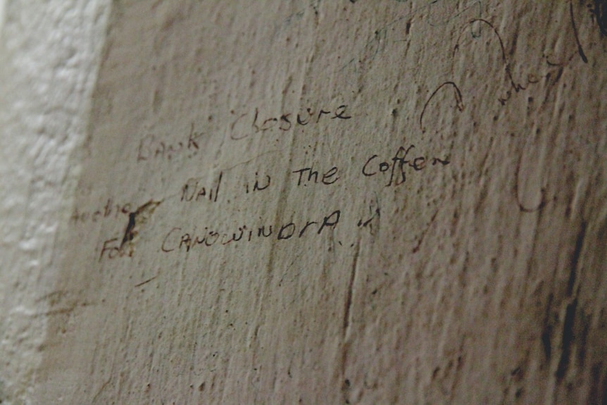An inscription inside the safe which reads "bank closure, another nail in the coffin for Canowindra."
