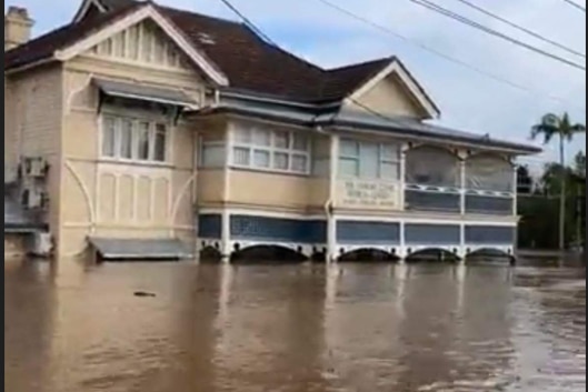 old building surrounded by flood water