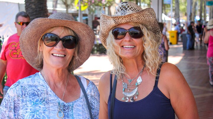 Two ladies from Perth in their hats downtown at the Tamworth Country Music Festival