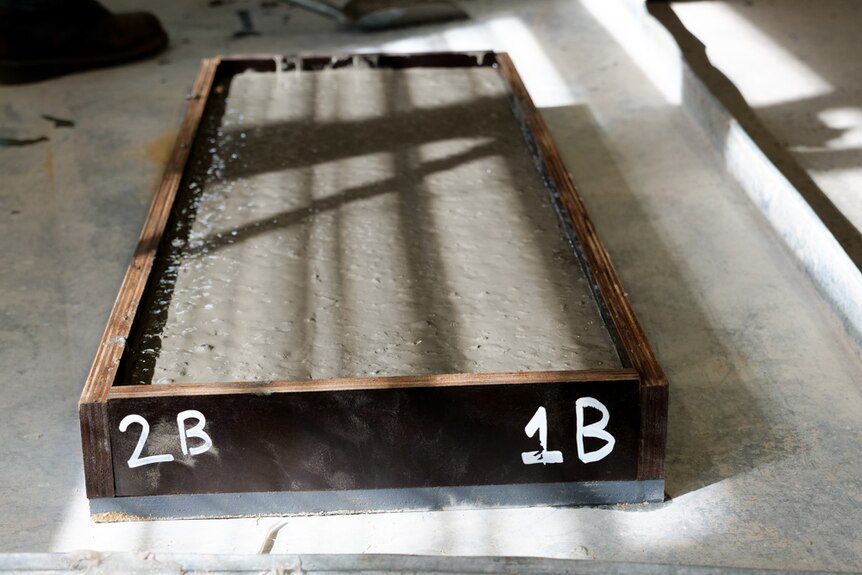 A wooden slab filled with cement 