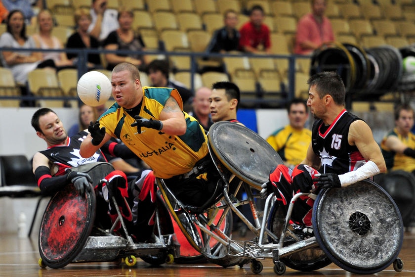 Players bump into each other in a wheelchair rugby match.